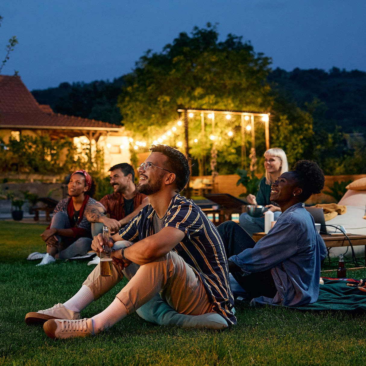 people sitting outside at night stargazing
